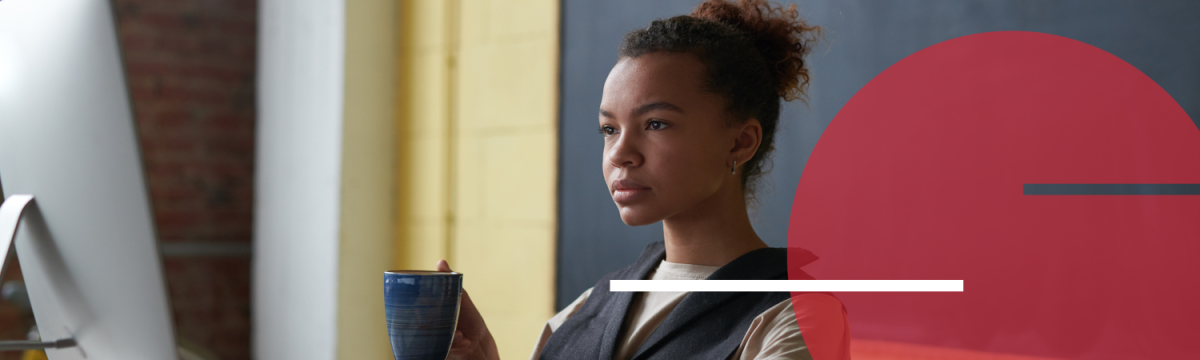 Woman holding a hot drink taking part in a webinar